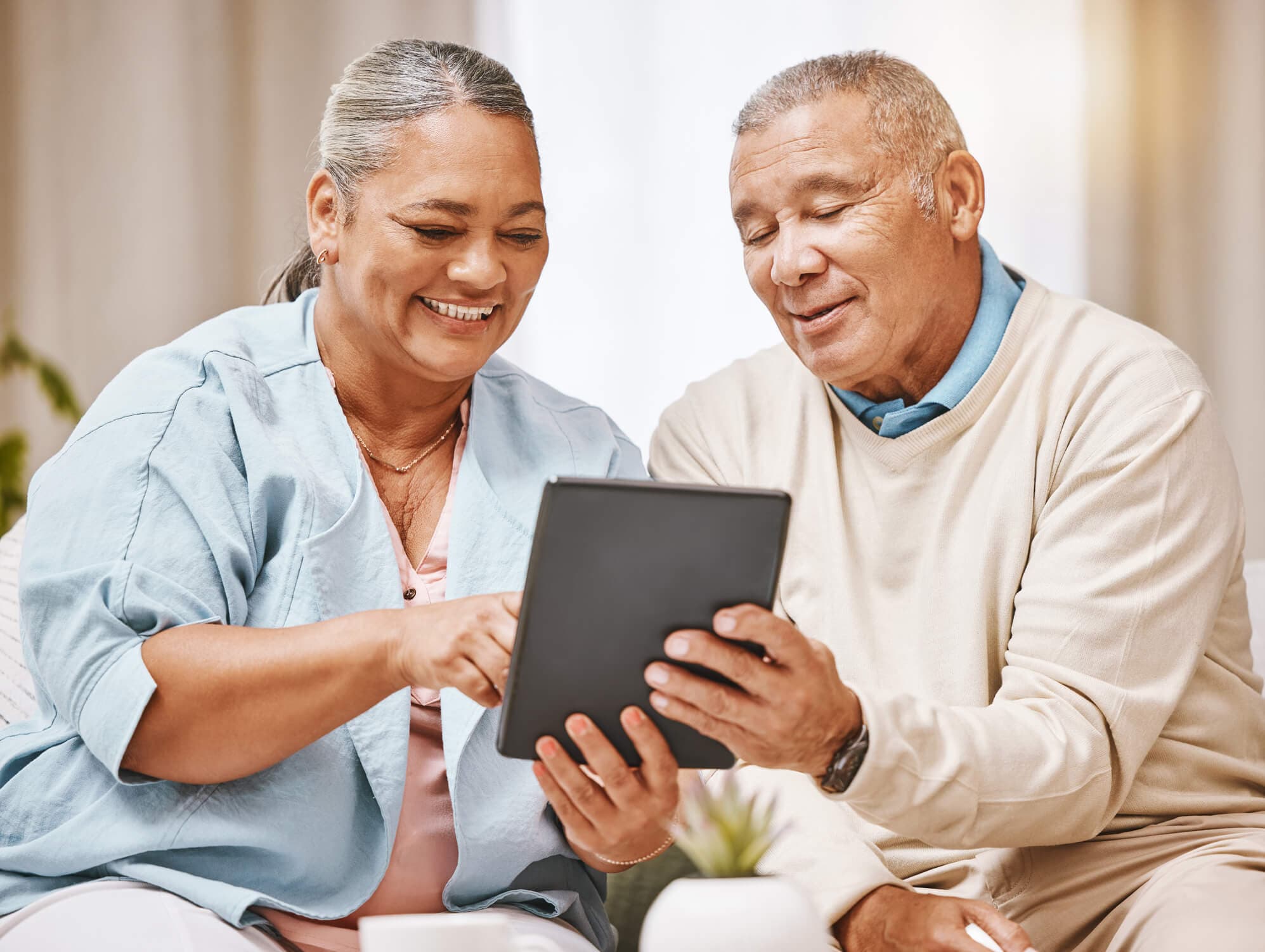 Elderly couple looking at a tablet together